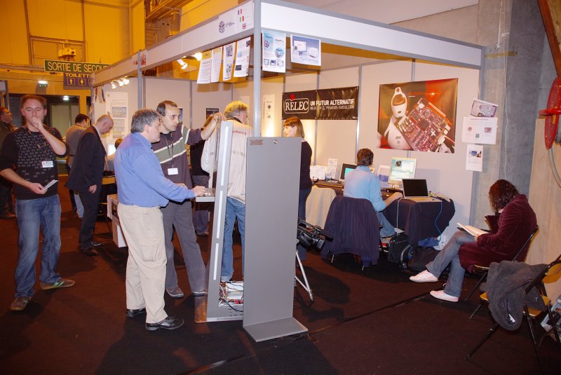 The Relec/ACube stand. Enrico and Elwood can't stop playing around with that touch-screen.