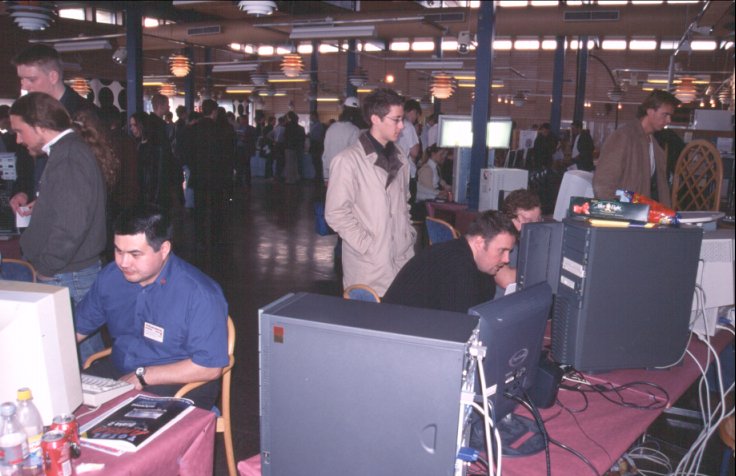 28: The AmigaOne corner from behind. Closest to the camera is the one belonging to Kjell from AmiGBG, one of the busy arrangers of the event. Justin is to the left, and to the right is Ole-Egil's machine with himself almost hidden behind it (I think).