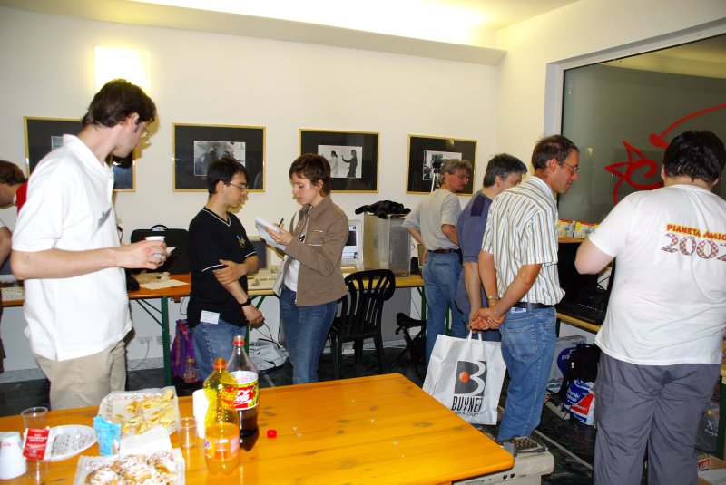 Back in the main hall, a reporter from a regional newspaper is busy covering the event, while others sample the nice "refreshment" table. There were, at various times during the day, pizza, sandwiches, snacks, cakes, cookies, soda, water, wine, beer, and probably lots of other stuff. And it was all for free. Really nice!