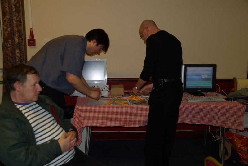 Mike "Vision" Hunt in the foreground waiting while Robert and Mick prepare the raffle tickets.